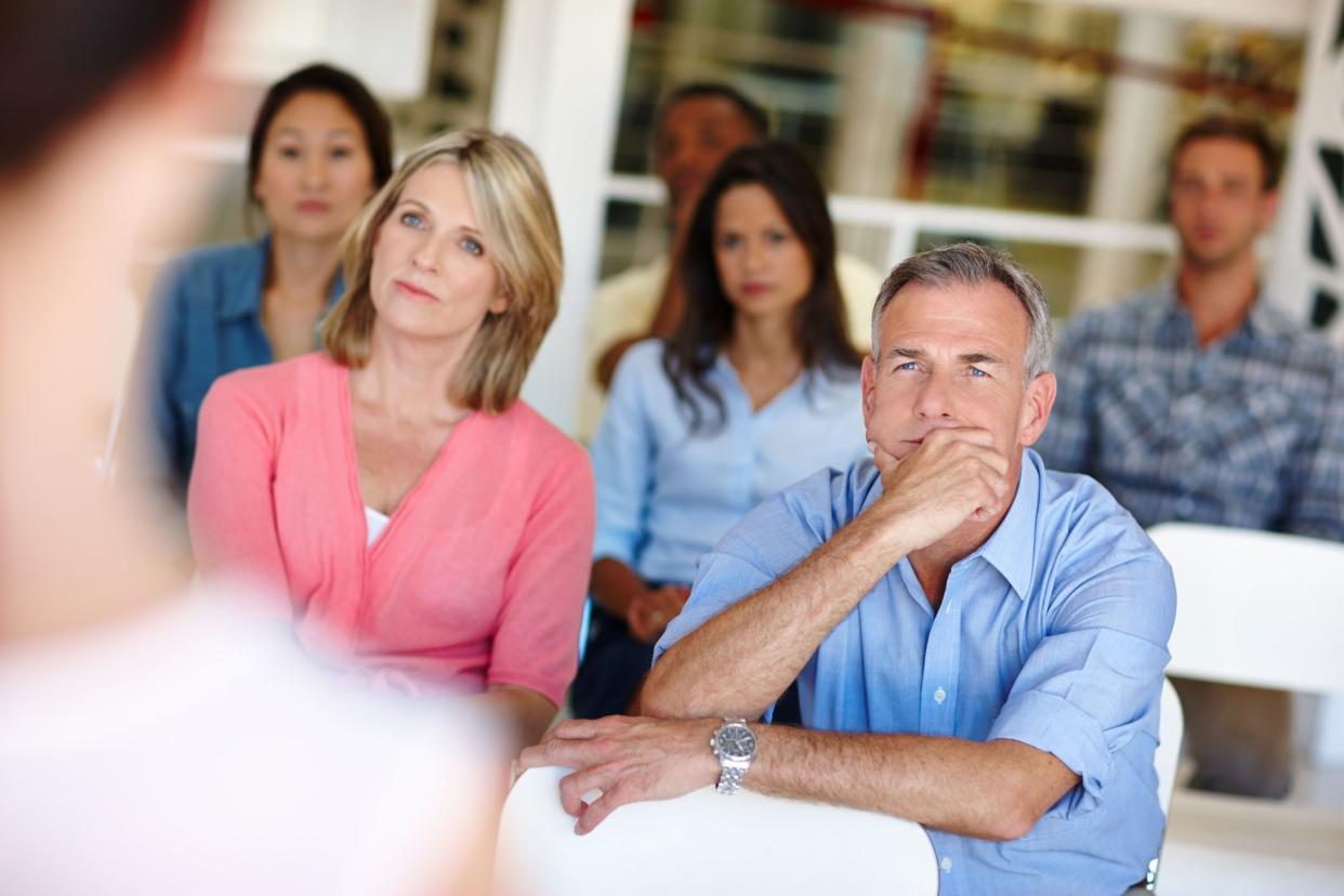 couple with serious expression at auction