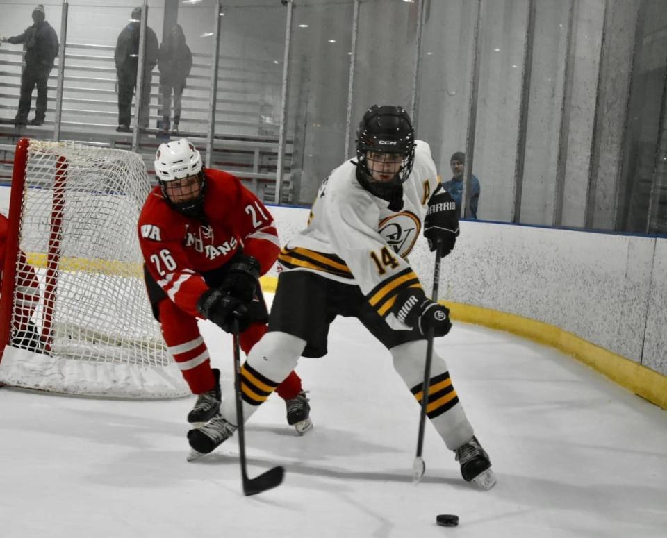 Quaker Valley's Braedan Steffey looks to control the puck against West Allegheny's Nicholas Sabo.