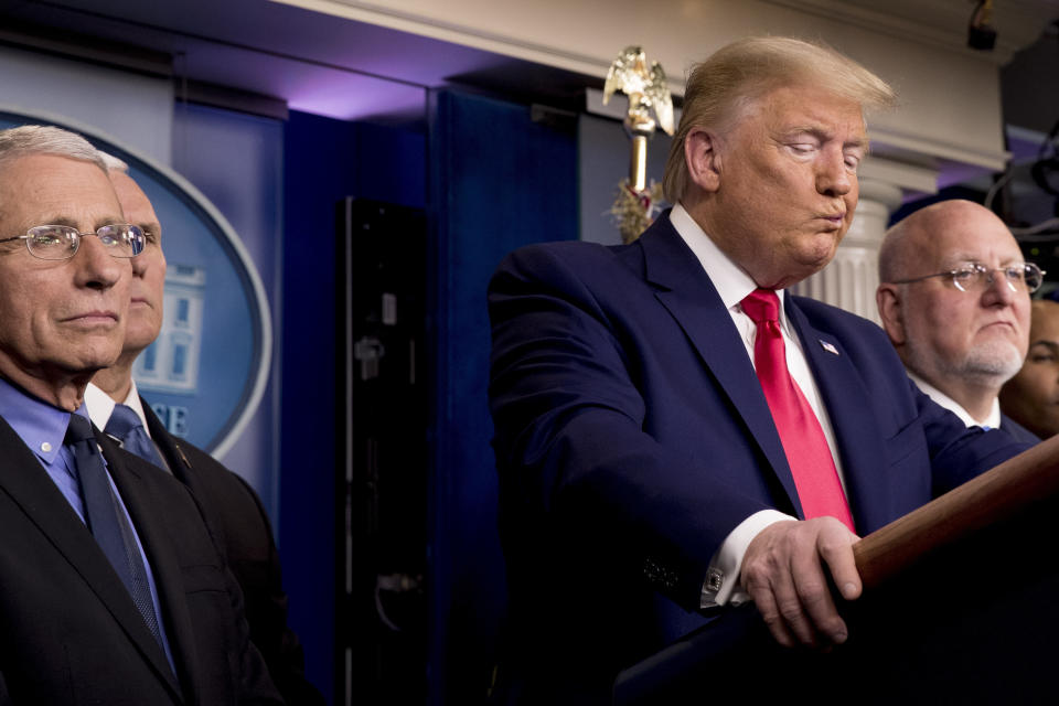 FILE - In this Feb. 29, 2020 file photo, President Donald Trump, accompanied by, from left, National Institute for Allergy and Infectious Diseases Director Dr. Anthony Fauci, Vice President Mike Pence, and Robert Redfield, director of the Centers for Disease Control and Prevention, reacts to a question during a news conference on the coronavirus in the press briefing room at the White House in Washington. Public health officials were already warning Americans about the need to prepare for the coronavirus threat in early February when President Donald Trump called it “deadly stuff” in a private conversation that has only now has come to light. (AP Photo/Andrew Harnik, File)