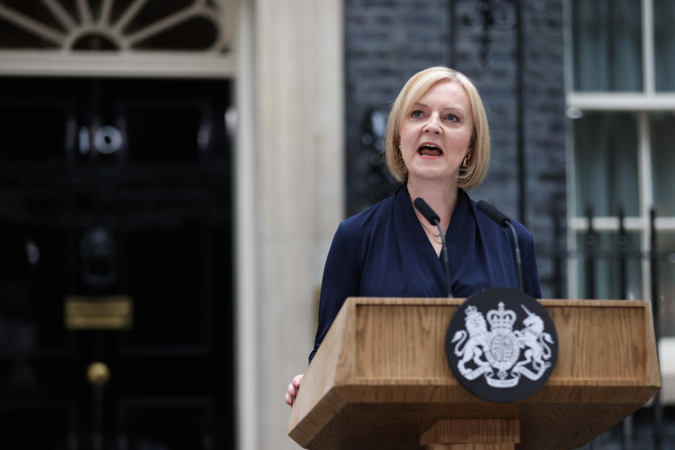 British Prime Minister Liz Truss stands at a podium and delivers a speech.