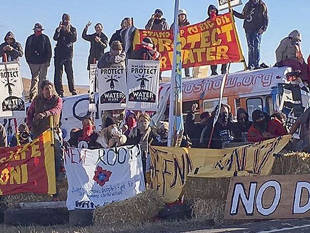 A handout picture made available by the Morton County Sheriff's Department shows protesters holding placards. Source: AP