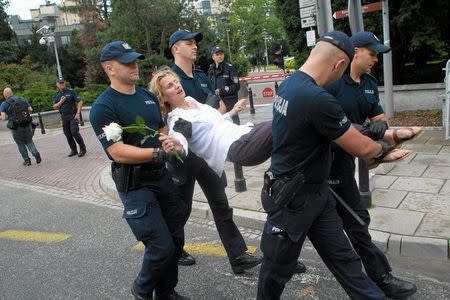 A protester is detained by the police during a demonstration against the Supreme Court legislation in Poznan, Poland, July 20, 2017. Agencja GazetaPrzemek Wierzchowsk/via REUTERS