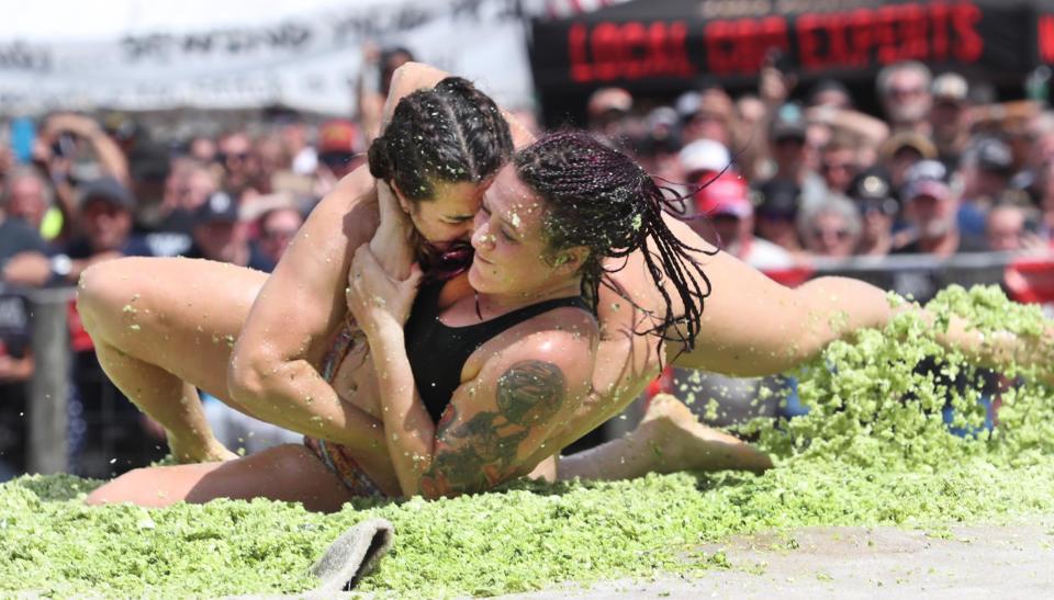 Shannon "Cookie" Cook tackles Katie Rineer as they wrestle in a pit of coleslaw at the Cabbage Patch Bar during the 2020 edition of Bike Week. Coleslaw wrestling remains one of the most popular events at Bike Week.