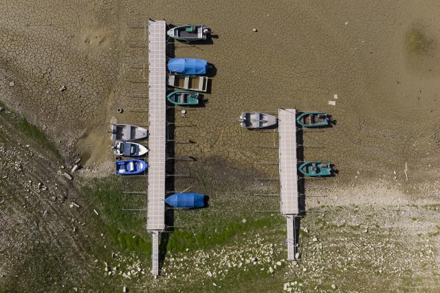 Stranded boats on the dried-out shore of Lac Brenet in Switzerland.