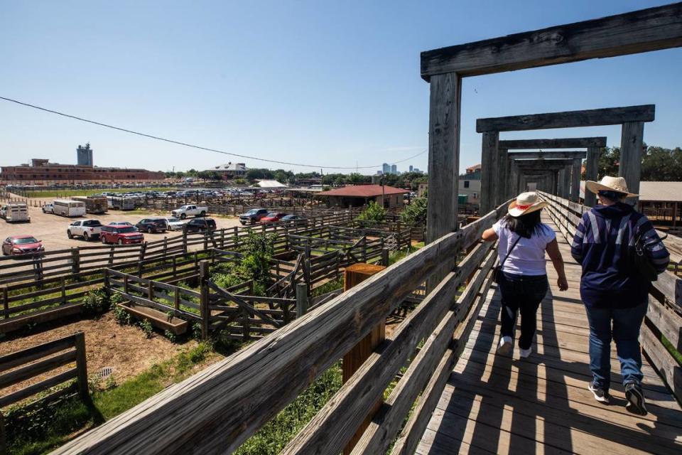 Guests walk over cattle pens for the Fort Worth Herd On Friday June 7 at the Fort Worth Stockyards. New developments were proposed to the city council that would build new steer pens, parking garages and a full-service hotel