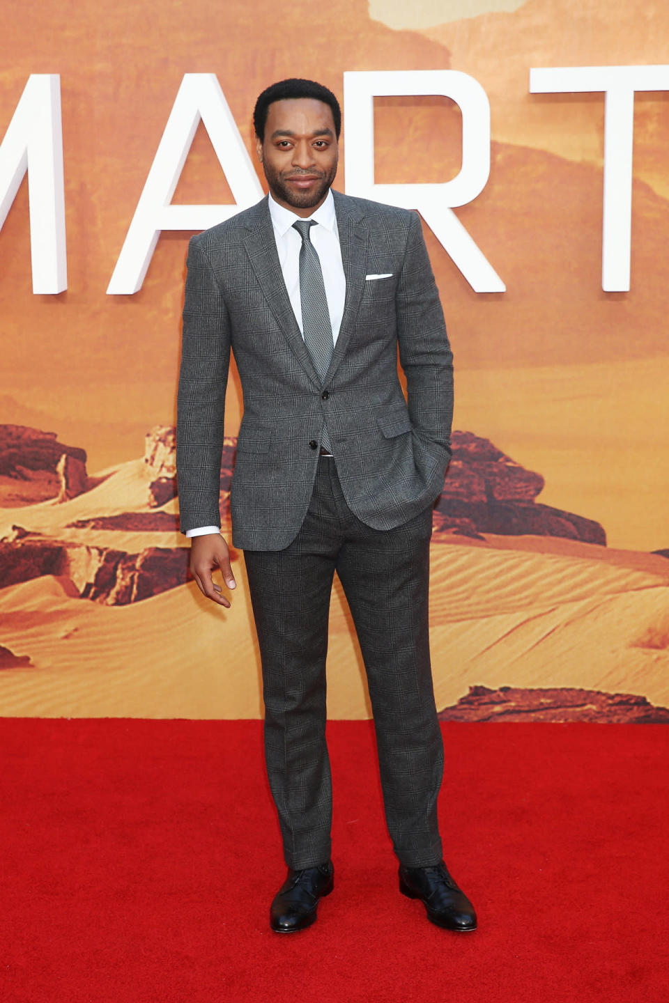 Chiwetel Ejiofor in a dark gray suit at the London premiere of ‘The Martian’ at Odeon Leicester Square.