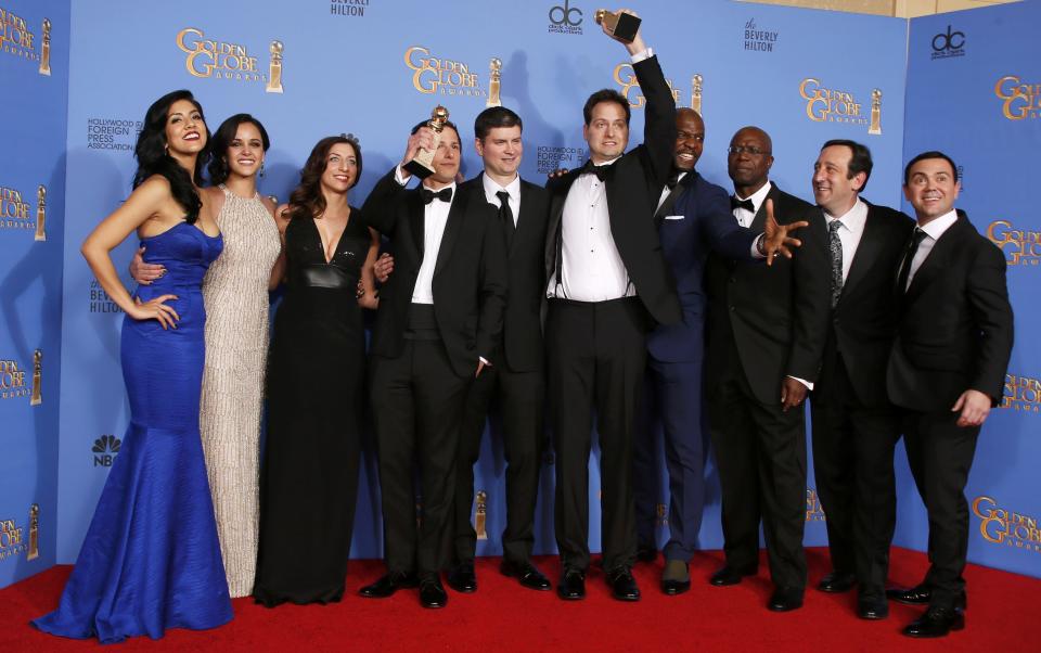 Cast and crew of Brooklyn Nine Nine poses backstage with their Best Television Series - Comedy or Musical at the 71st annual Golden Globe Awards in Beverly Hills