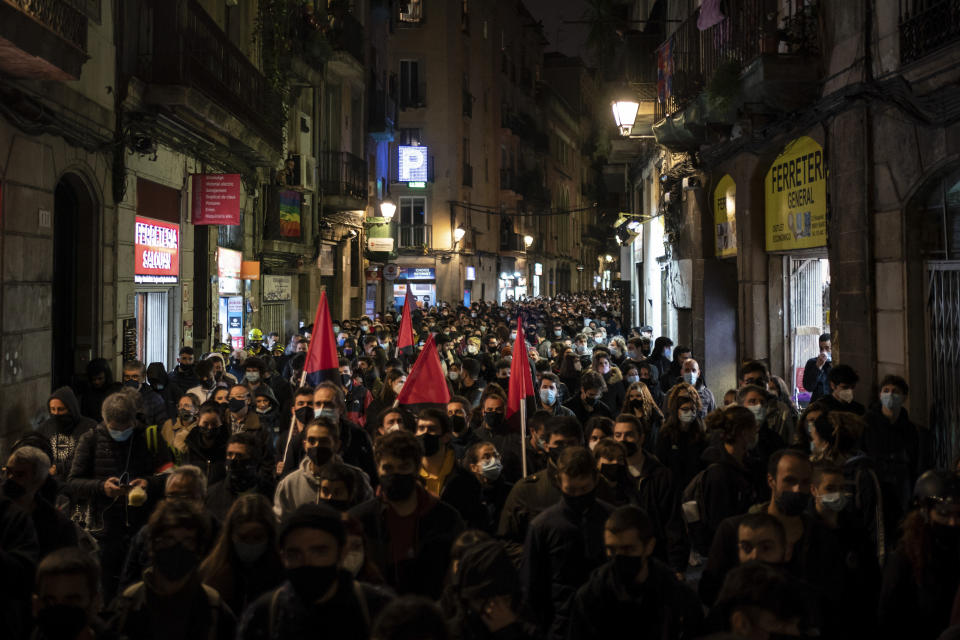 Demonstrators march during a protest condemning the arrest of rap singer Pablo Hasél in Barcelona, Spain, Saturday, Feb. 27, 2021. After a few days of calm, protests have again turned violent in Barcelona as supporters for a jailed Spanish rapper went back to the streets. (AP Photo/Felipe Dana)