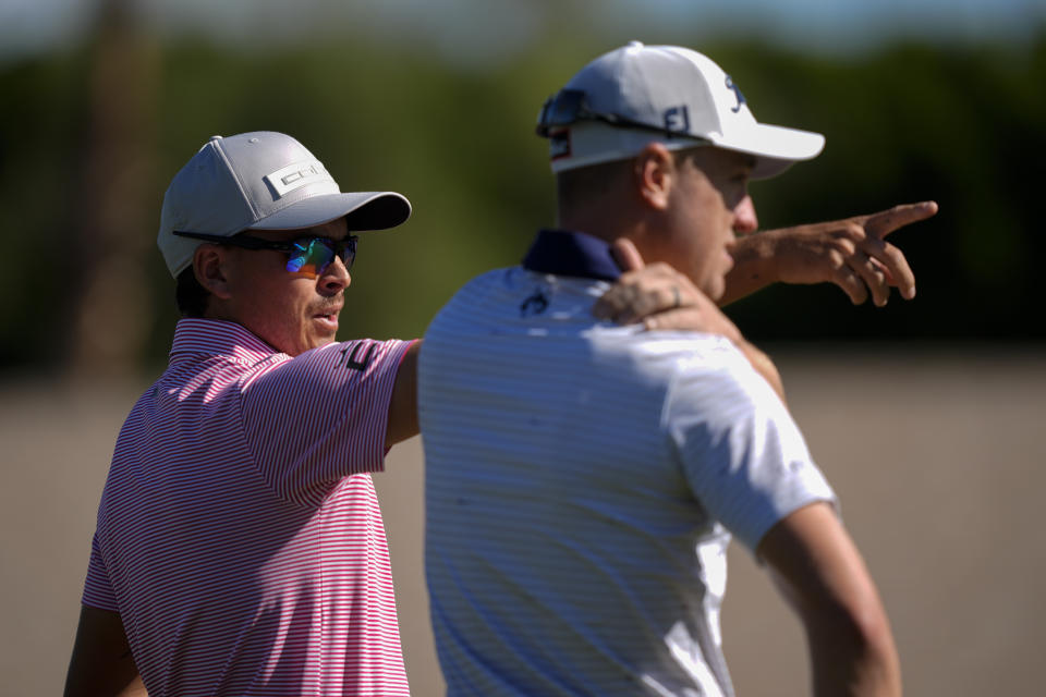 Rickie Fowler, left, points alongside Justin Thomas on the fifth hole of the La Quinta Country Club course during the first round of the American Express golf tournament, Thursday, Jan. 18, 2024, in La Quinta, Calif. (AP Photo/Ryan Sun)