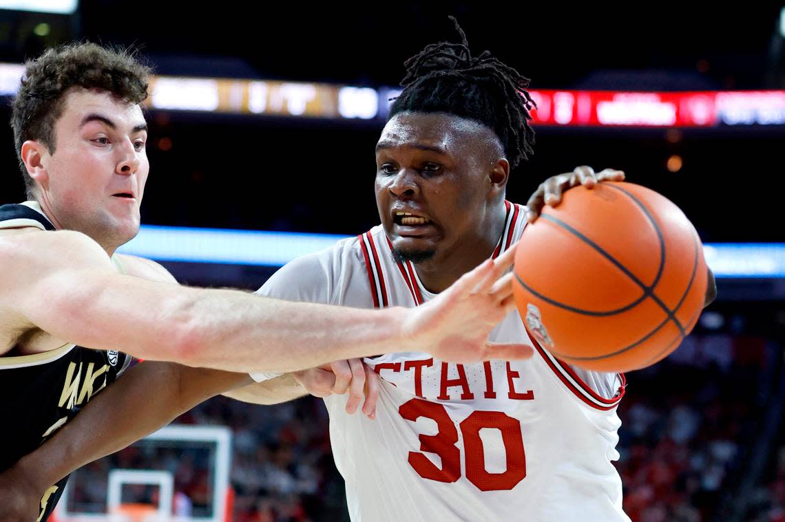 N.C. State’s D.J. Burns Jr. (30) keeps the ball from Wake Forest’s Matthew Marsh (33) during the second half of N.C. State’s game against Wake Forest at PNC Arena in Raleigh, N.C., Wednesday, Feb. 22, 2023.