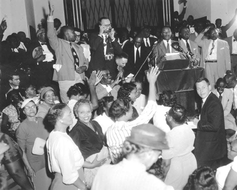 The Rev. Martin Luther King Jr. is cheered by supporters as he announced that he would continue boycotting the bus lines in Montgomery, Ala., on April 26, 1956.  (AP Photo)