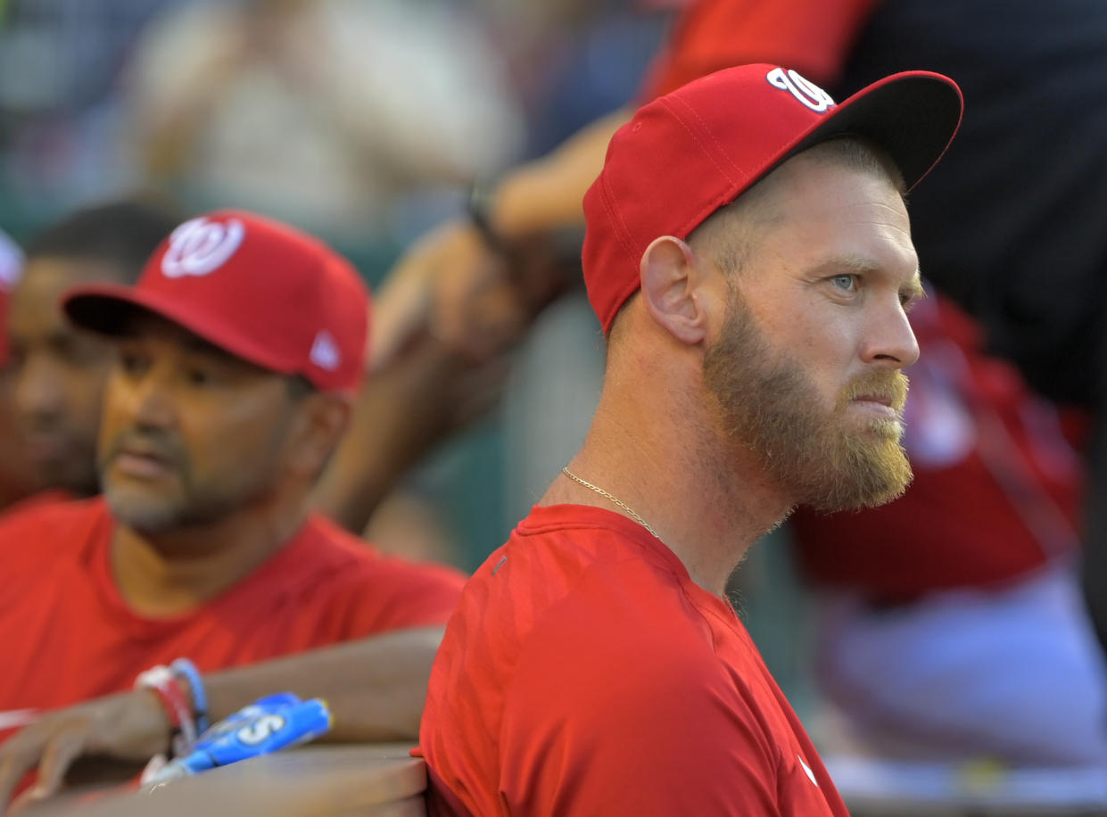 WASHINGTON, DC- AUGUST 31:Washington Nationals manager Dave Martinez (4), left, with injured pitcher Stephen Strasburg during the Washington Nationals defeat of the Oakland As 5-1 at Nationals Park on August 31, 2022 in Washington, DC. (Photo by John McDonnell/The Washington Post via Getty Images)