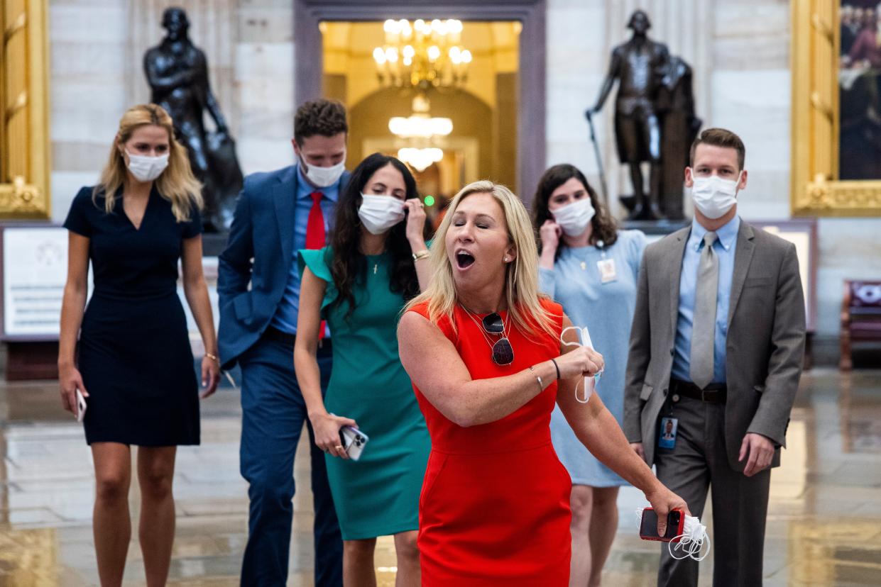 Marjorie Taylor Greene removes rips off mask crossing from House to Senate side of Capitol, where masks were not required (EPA)