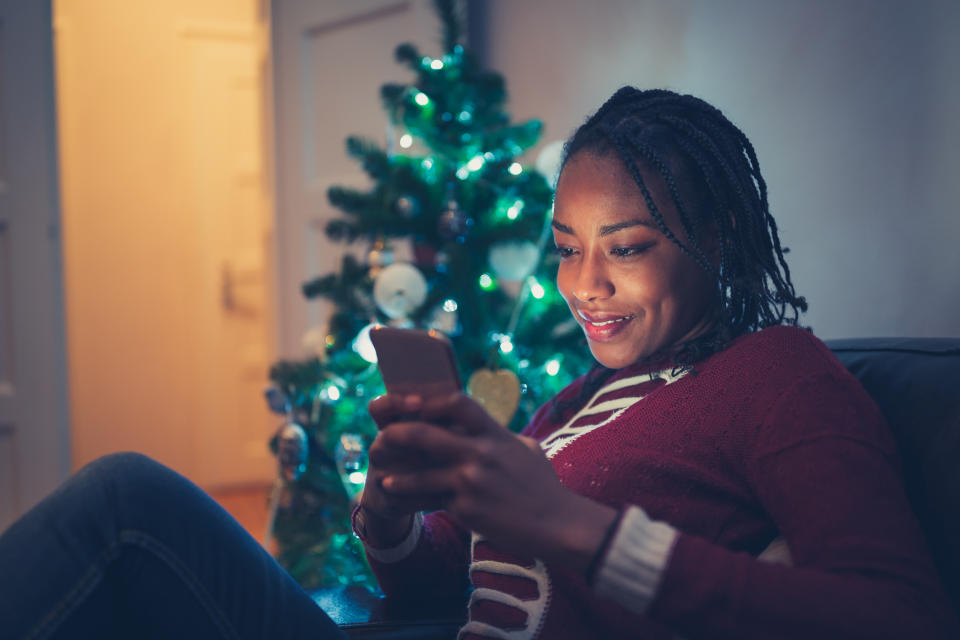 African American woman buying Christmas gifts online