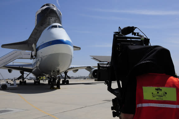 A cameraman shoots the space shuttle Endeavour after its arrival at Los Angeles International Airport on Sept. 21, 2012.
