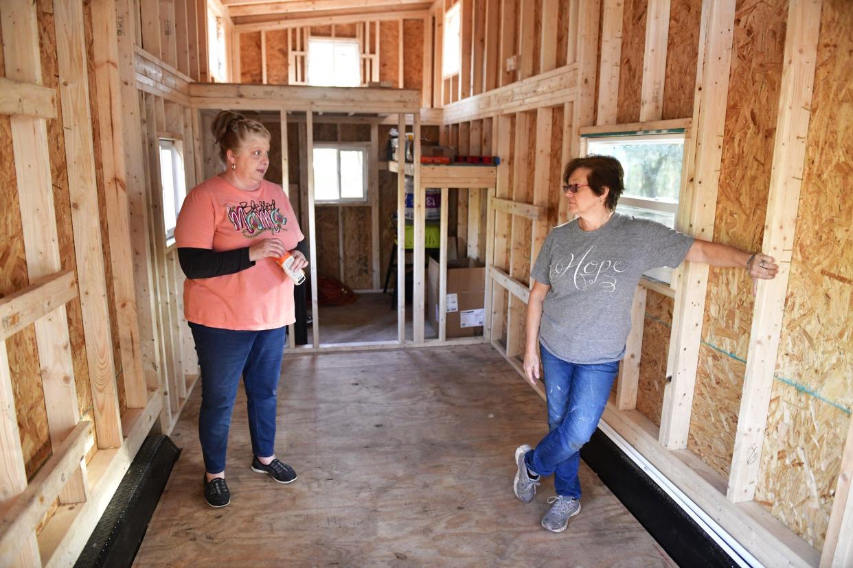 Founders Carla Sweeney (left) and Donna Fenchel talk inside a tiny home in Jacksonville. Their new nonprofit, The Villages of Hope, is building a tiny-home community on the Westside for human-trafficking survivors.