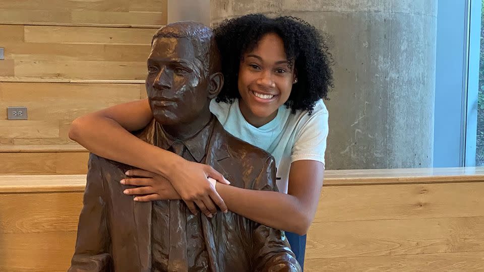 Deanna Yancey smiles with a statue of her grandfather, Ronald, who was the first Black student to graduate from Georgia Tech in 1965. - Courtesy Deanna Yancey