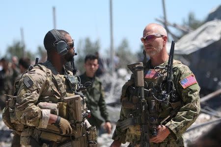 U.S. forces are seen at the Kurdish People's Protection Units (YPG) headquarters after it was hit by Turkish airstrikes in Mount Karachok near Malikiya, Syria April 25, 2017. REUTERS/ Rodi Said