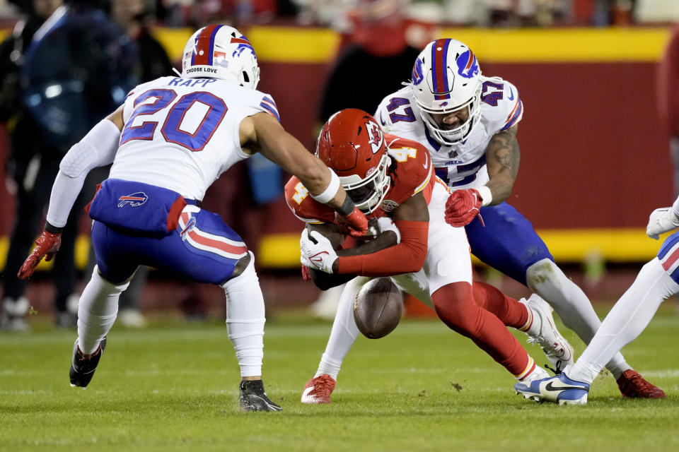Kansas City Chiefs wide receiver Rashee Rice (4) fumbles as Buffalo Bills safety Taylor Rapp (20) and cornerback Christian Benford (47) defend during the second half of an NFL football game Sunday, Dec. 10, 2023, in Kansas City, Mo. (AP Photo/Charlie Riedel)