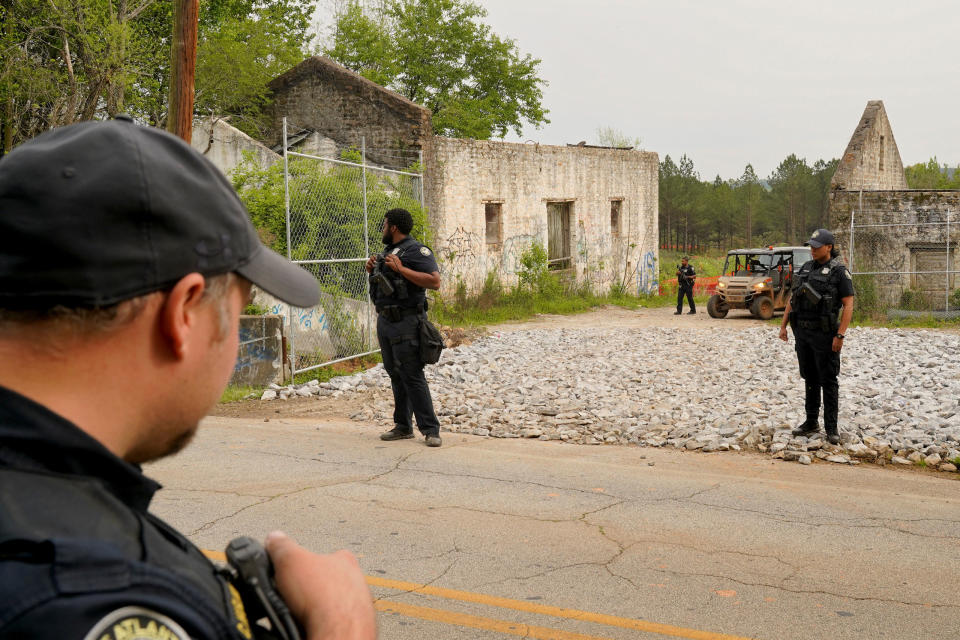 Law enforcement officers guard the entrance of the planed site of a controversial “Cop City” project as the clear cutting of trees begins near Atlanta on March 31, 2023.<span class="copyright">Cheney Orr—Reuters</span>