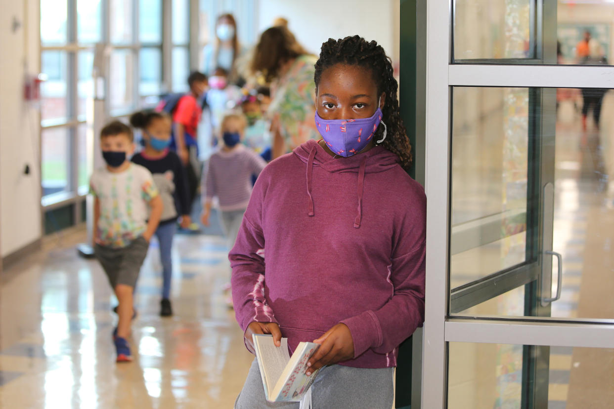 Fifth Grader Utibe Edet in a hallway at Bielefield Elementary School in Middletown, CT. Masks are required at the school. (Stan Godlewski for The Washington Post via Getty Images)