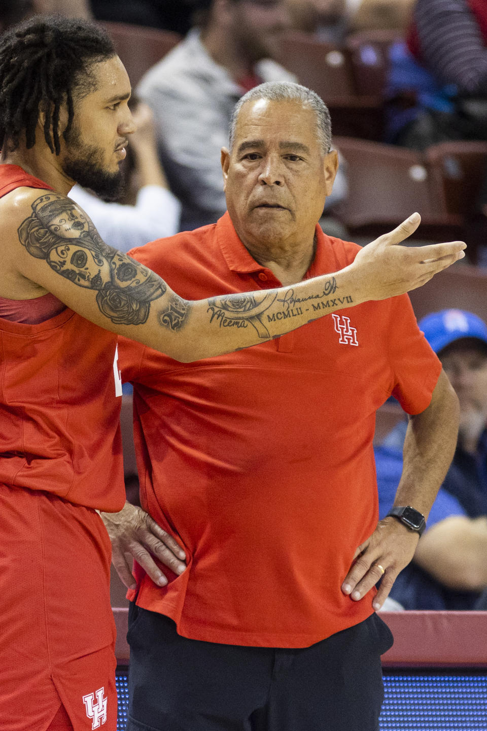 Houston's head coach Kelvin Sampson, right, talks with player Emanuel Sharp, left, in the second half against Towson of an NCAA college basketball game during the Charleston Classic in Charleston, S.C., Thursday, Nov. 16, 2023. (AP Photo/Mic Smith)