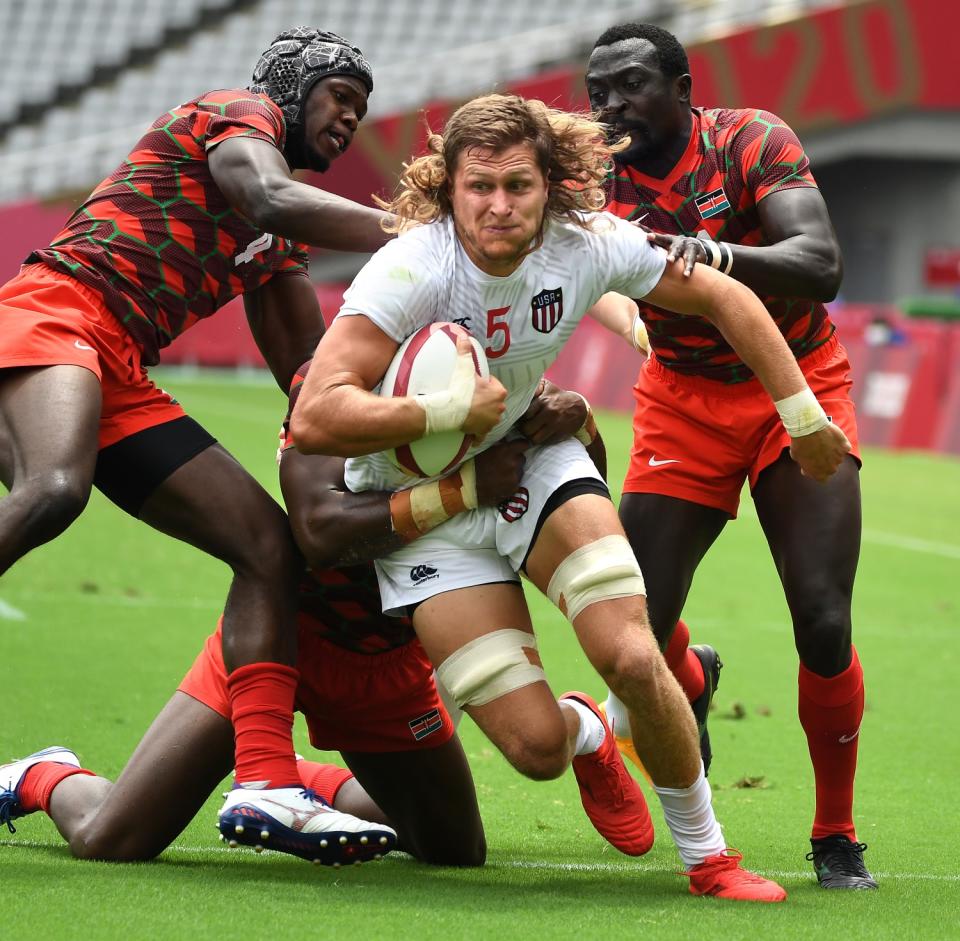 USA's Joe Schroeder is brought down by Kenya defenders