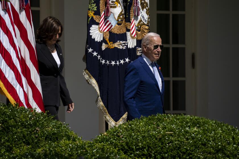 WASHINGTON, DC - JULY 11: President Joe Biden, followed by Vice President Kamala Harris walk from the Oval Office to the South Lawn for an event commemorating the of the passage of the Bipartisan Safer Communities Act at the White House on Monday, July 11, 2022 in Washington, DC. The White House invited lawmakers, gun violence victims and supporters to the White House to commemorate the passage of a new law that it describes as "the most significant gun violence reduction legislation in the last 30 years." (Kent Nishimura / Los Angeles Times)