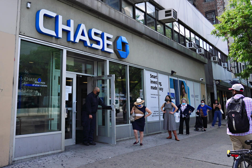 NEW YORK, NEW YORK - MAY 29:  People wait in line outside CHASE bank to use the ATM machine during the coronavirus pandemic on May 29, 2020 in New York City. Government guidelines encourage wearing a mask in public with strong social distancing in effect as all 50 states in the USA have begun a gradual process to slowly reopen after weeks of stay-at-home measures to slow the spread of COVID-19. (Photo by Cindy Ord/Getty Images)