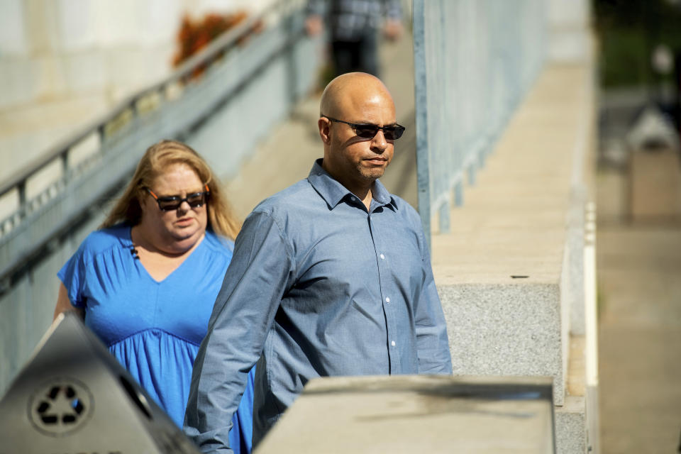 David Gregory, who's daughter Michela Gregory died in the 2016 Ghost Ship warehouse fire, leaves Alameda County Superior Court on Monday, Aug. 19, 2019, in Oakland, Calif. At left is Karen Bourdon Frieholtz. Three jurors were dismissed Monday for undisclosed reasons on the 10th day of deliberations in the trial of two men charged in the deaths of 36 partygoers from a fire inside a cluttered San Francisco Bay Area warehouse. (AP Photo/Noah Berger)