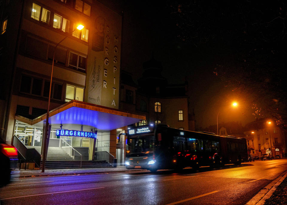 A bus drives past a hospital in Frankfurt, Friday, Nov. 19, 2021. The government announced that the hospitalization rate will decide about further restrictions to avoid the outspread of the coronavirus. (AP Photo/Michael Probst)