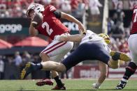 Michigan's Aidan Hutchinson stops Wisconsin's Chase Wolf during the second half of an NCAA college football game Saturday, Oct. 2, 2021, in Madison, Wis. (AP Photo/Morry Gash)