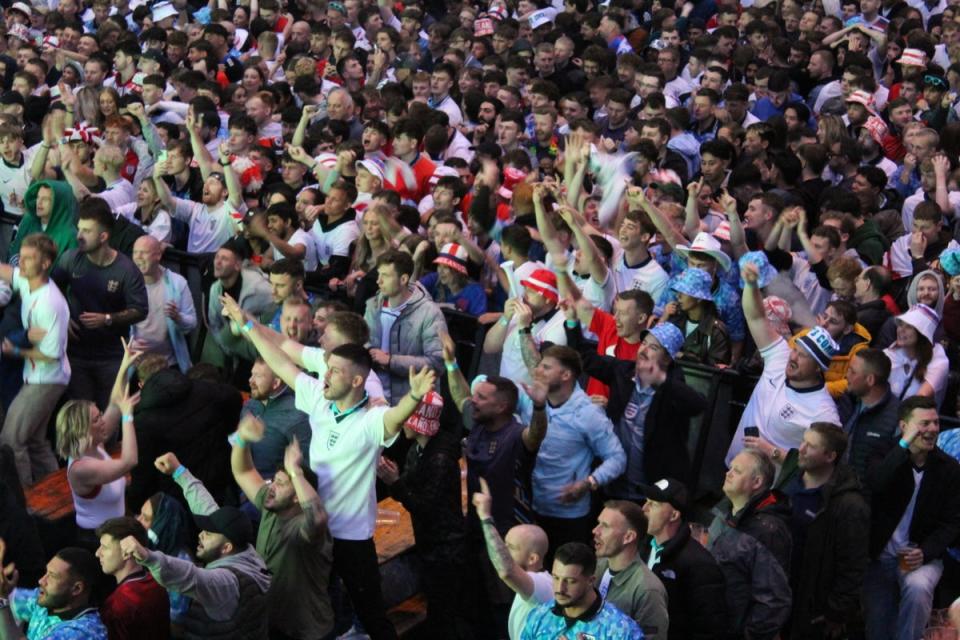 England fans throw beers in the air and break out into a rendition of “Football’s coming home” after Cole Palmer scores (Tom Watling)