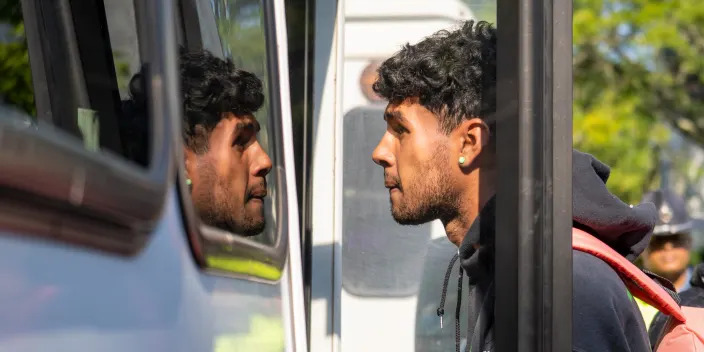 A person is seen boarding a bus.