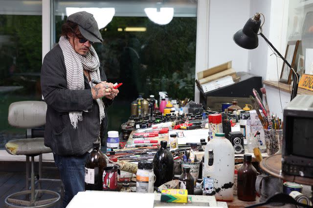 <p>Image Courtesy of Castle Fine Art | Elliot-Nyman</p> Johnny Depp working on his self-portrait 'Five'