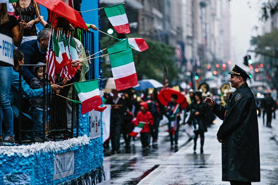 <p>A police officer (R) looks as people with Italian flags march Fifth Avenue during the 73rd Annual Columbus Day Parade in New York, Oct. 9, 2017, celebrating the anniversary of Christopher Columbus’s arrival in the Americas in 1492. (Photo: Alba Vigaray/EPA-EFE/REX/Shutterstock) </p>