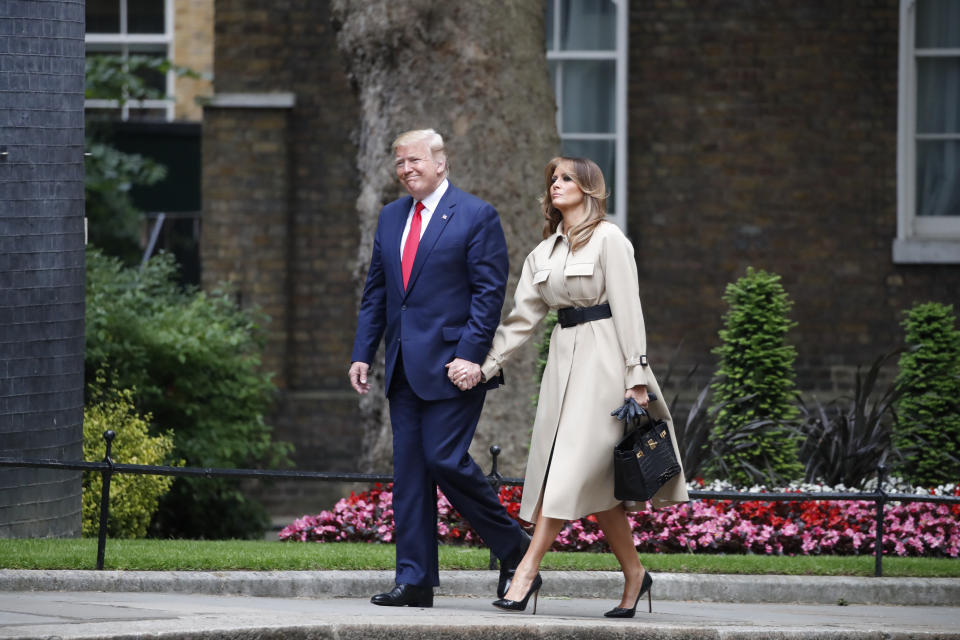 President Donald Trump and first lady Melania Trump walk to 10 Downing Street, Tuesday, June 4, 2019, in London, to be greeted by British Prime Minister Theresa May and her husband Philip. (AP Photo/Alex Brandon)