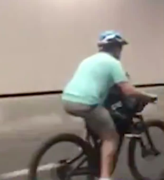 The child appeared to be sharing the same bike seat as the man as they made their way through the Lane Cove Tunnel.