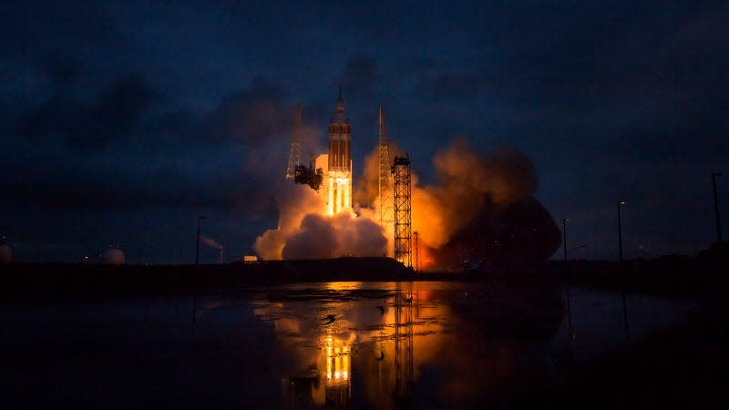 A photo of a Delta IV rocket launching at night. 