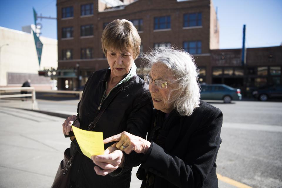 Helen Mulroney and Jo Anne Troxel check out a flyer.