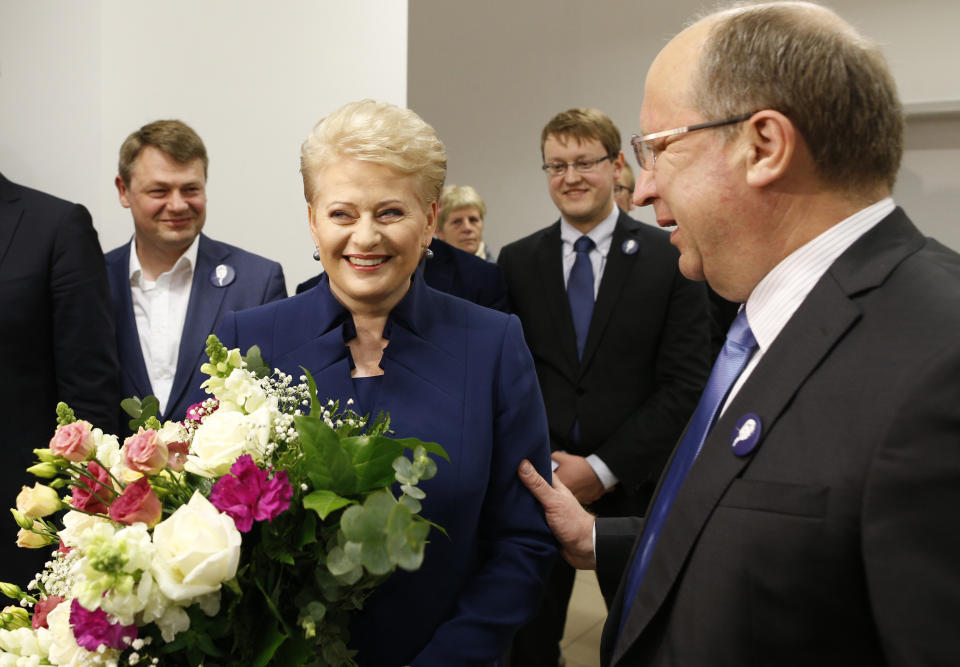 Lithuania's former Prime minister Andrius Kubilius,right, congratulates Lithuania's President Dalia Grybauskaite in a office as she waits for the results of Lithuania's presidential election first round in Vilnius, Lithuania, Sunday, May 11, 2014. Dalia Grybauskaite is widely expected to be re-elected for a second term. (AP Photo/Mindaugas Kulbis)