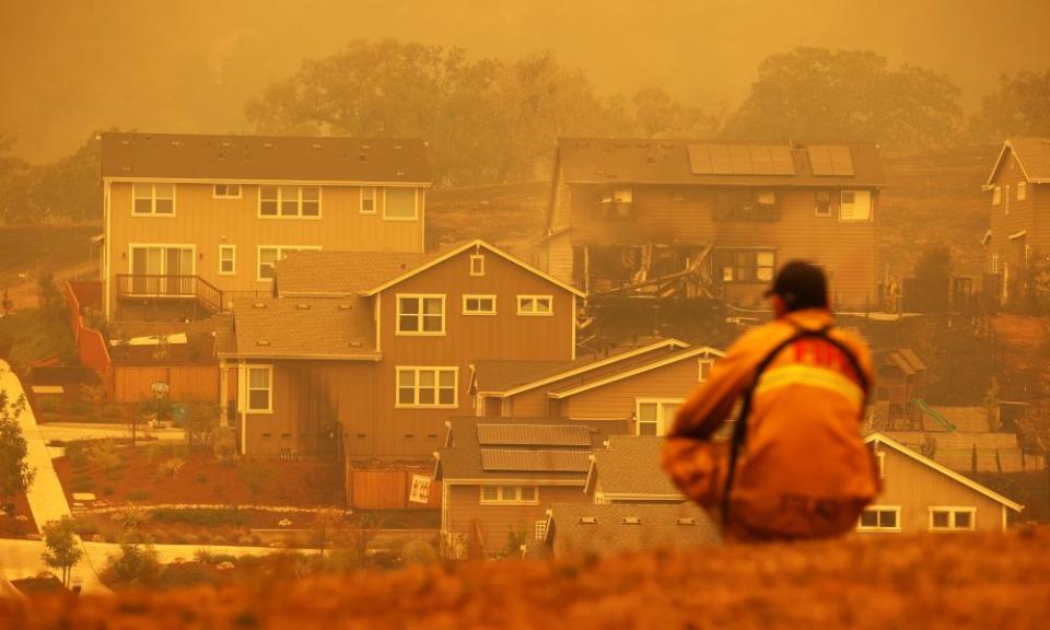 A firefighter looks towards a home that was destroyed by the Glass incident fire on Tuesday in Santa Rosa, California.