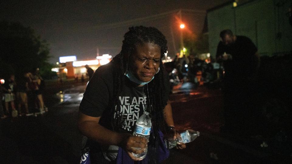 Cori Bush uses water to rinse her face after being tear-gassed by police in Florissant, Missouri, on July 5. She went back to campaigning for Congress the following morning. (Lawrence Bryant/Reuters)