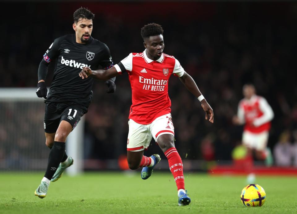 Bukayo Saka of Arsenal is tackled by Lucas Paqueta of West Ham United during the Premier League match between Arsenal (Getty Images)