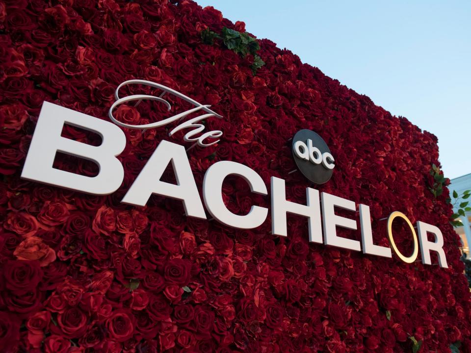 the bachelor logo on a red rose background