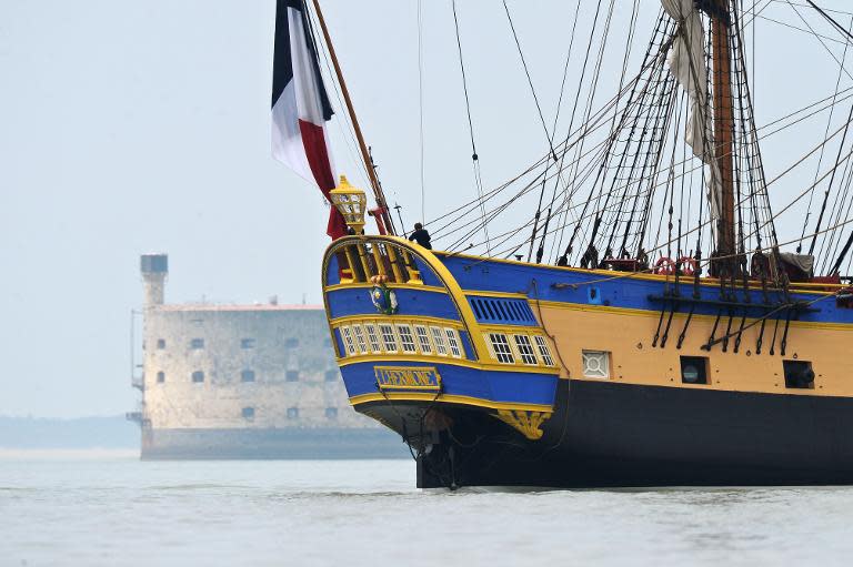 A replica of the French navy frigate L'Hermione passes Fort Boyard as it sets sail on its maiden voyage to the United States from Fouras, southwestern France on April 18, 2015