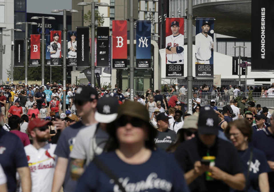 FILE - In this June 29, 2019, file photo, fans arrive before a baseball game between the Boston Red Sox and the New York Yankees, in London. Major League Baseball is trying to muscle in on a crowded marketplace in Britain dominated by soccer but also filled with cricket, rugby _ and this month Wimbledon. (AP Photo/Tim Ireland, File)