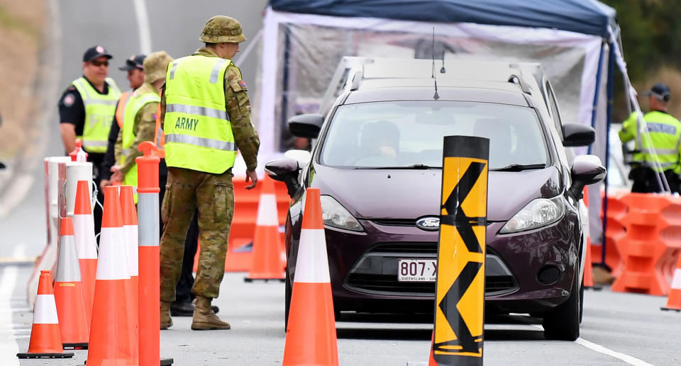 Defence personnel are seen at a checkpoint on the Queensland-New South Wales border in Coolangatta on the Gold Coast. Source: AAP