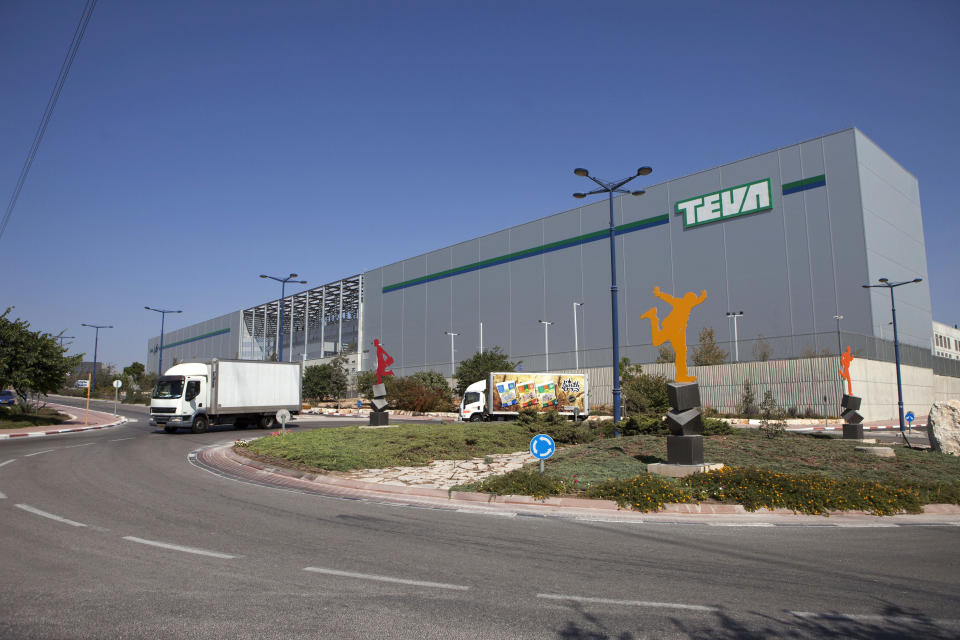 FILE - In this Wednesday, Oct. 16, 2013, file photo, trucks drive in front of Teva Pharmaceutical Logistic Center in the town of Shoam, Israel. Israeli drug maker Teva Pharmaceutical Industries on Thursday reported a third-quarter loss as it proceeds with an aggressive cost-cutting program and adjusts to declines in key product categories. (AP Photo/Dan Balilty, File)