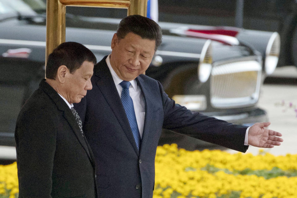 In this Oct. 20, 2016 file photo, Chinese President Xi Jinping, right, shows the way to Philippine President Rodrigo Duterte during a welcome ceremony outside the Great Hall of the People in Beijing, China. (AP Photo/Ng Han Guan, File)